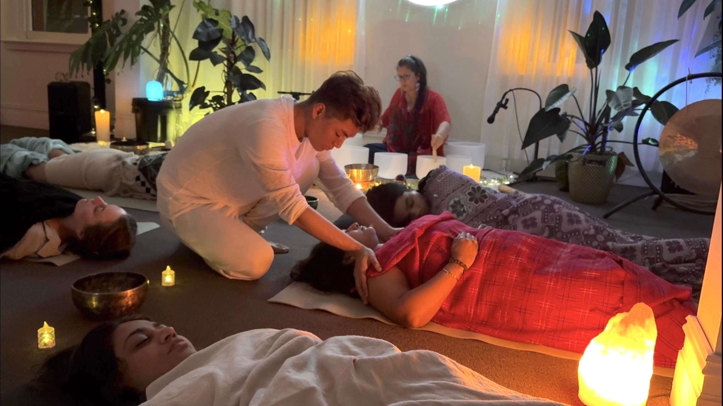 Phoenix offering gentle sound healing while Katrina Noela holds bowls at Mystic Wellness