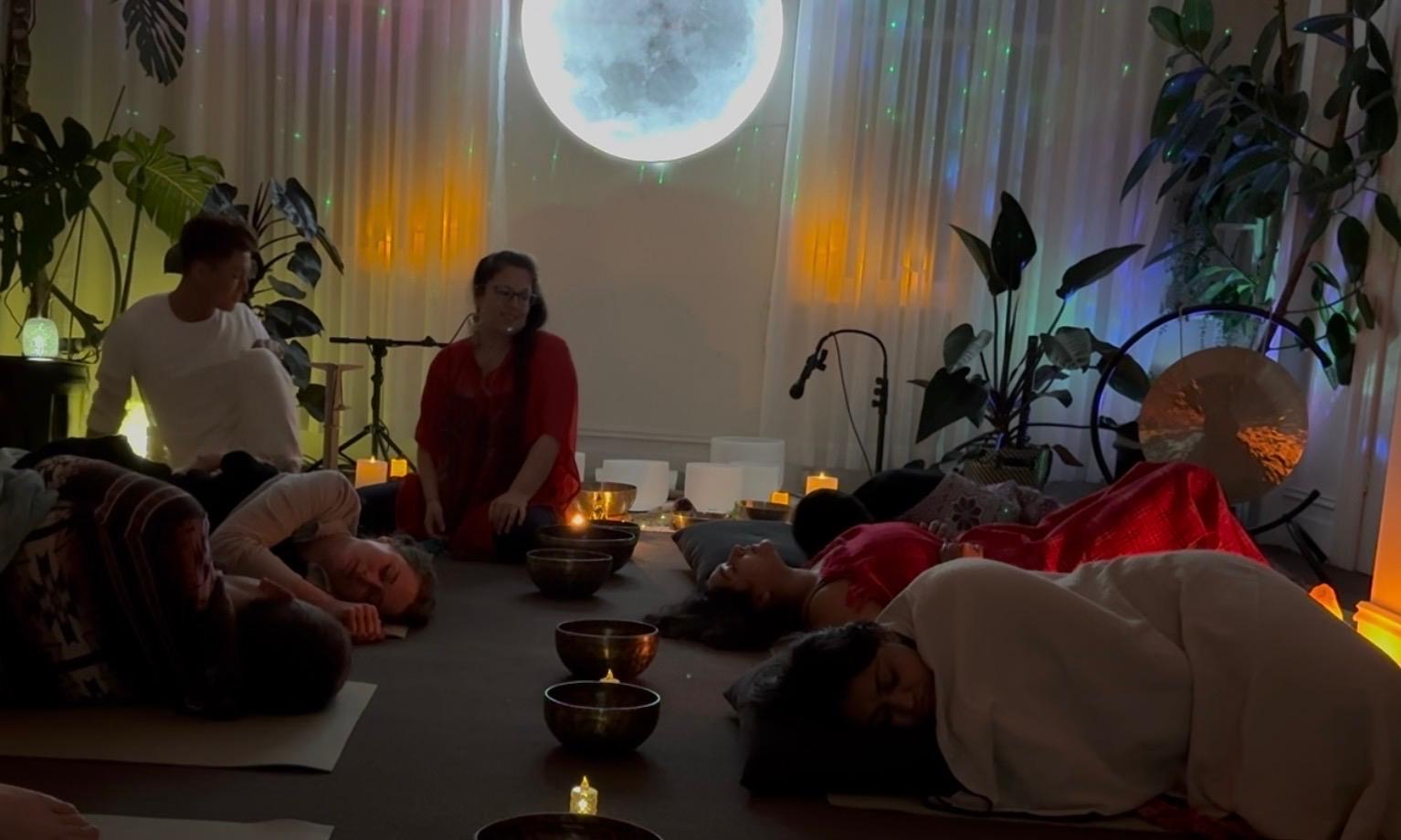 Guests resting during the Somatic Breath Stretch and Sound event at Mystic Wellness