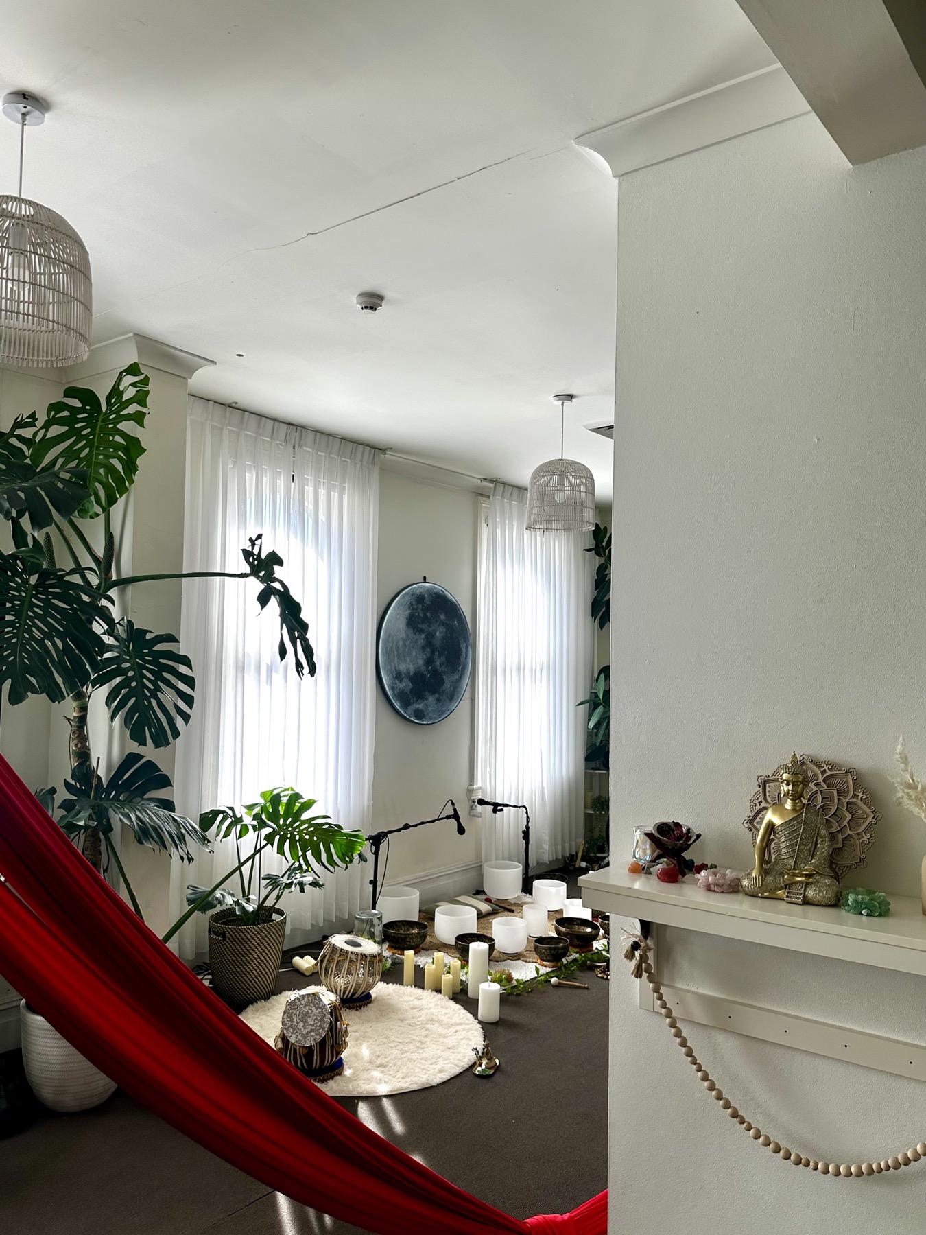 Mystic Wellness sanctuary with plants, moon wall, sound bowls, and altar